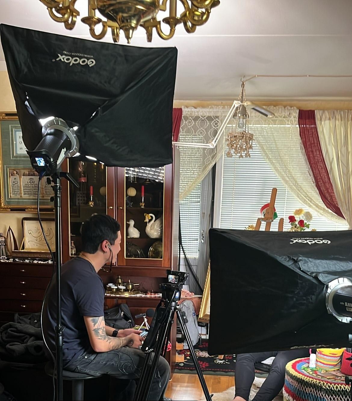 Interview setup with two Godox softboxes and a camera on a tripod in Walid’s living room