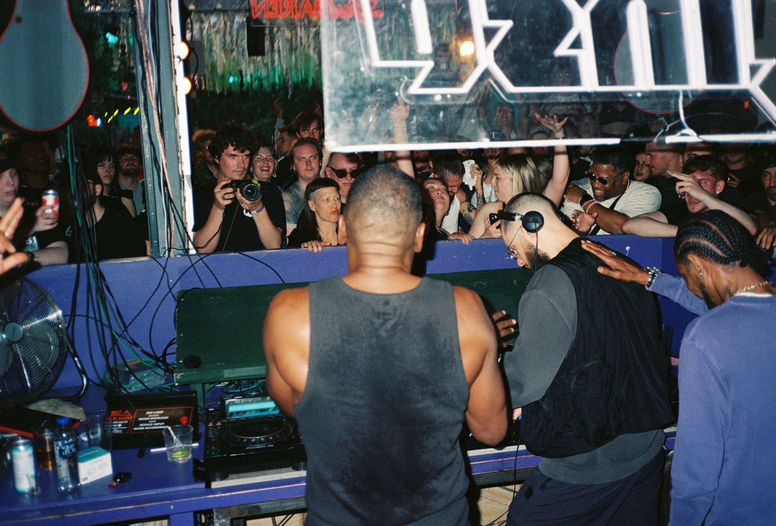 The booth from behind, photographers and crowd in front