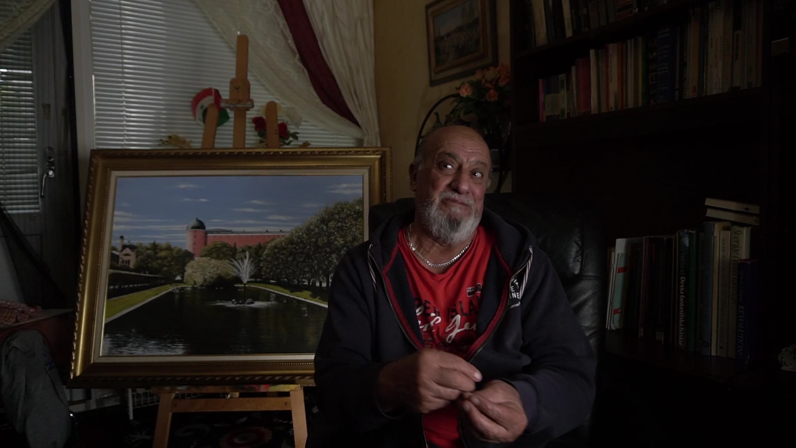 Uppsalabor: an artist interviewed in a room with a painting on an easel